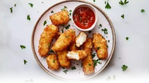 Plate of gluten-free mozzarella sticks with melted cheese and dipping sauce.