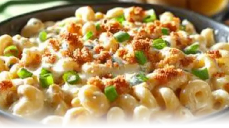 Golden buffalo mac and cheese with crispy breadcrumb topping in a modern kitchen setting.