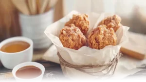 Playful Fried Chicken Ice Cream served in a basket with caramel and chocolate dipping sauces.