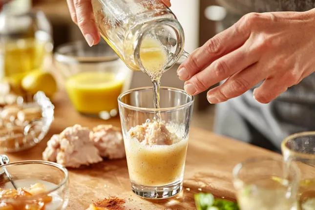 Preparing Fried Chicken Prime in a shaker bottle, mixing Prime Hydration and savory flavorings.