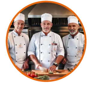 Three chefs from TrioRecipes cooking in a professional kitchen, showcasing fresh ingredients.